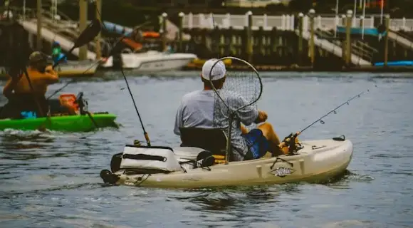 Man on fishing kayak.